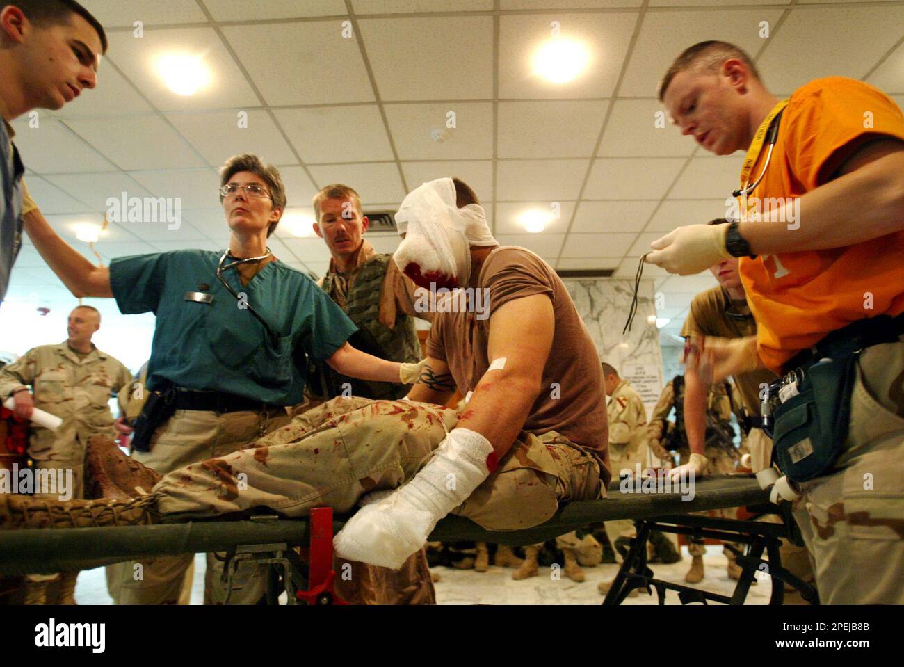 Hospital personel receive an American soldier suffering from shrapnel ...