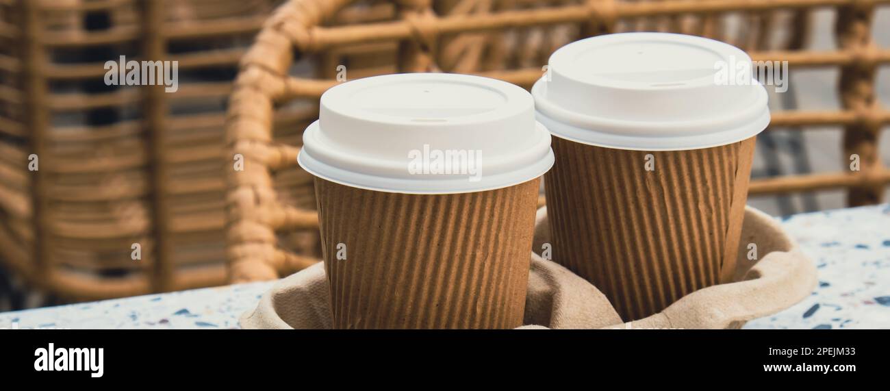 Two paper cups with lid for tea to go. Coffee take away on the table