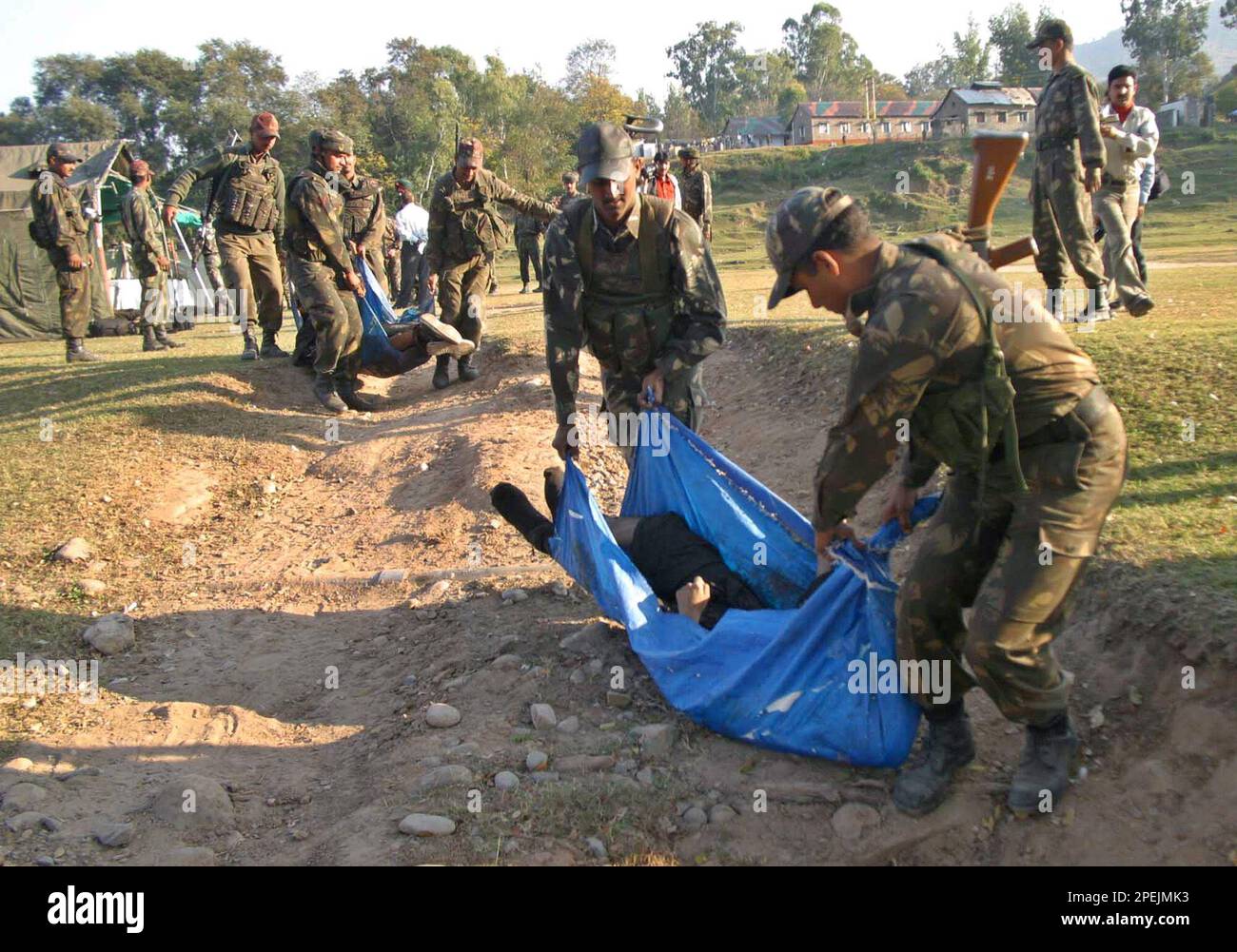 Indian Army soldiers carry the bodies of suspected militants in Punch