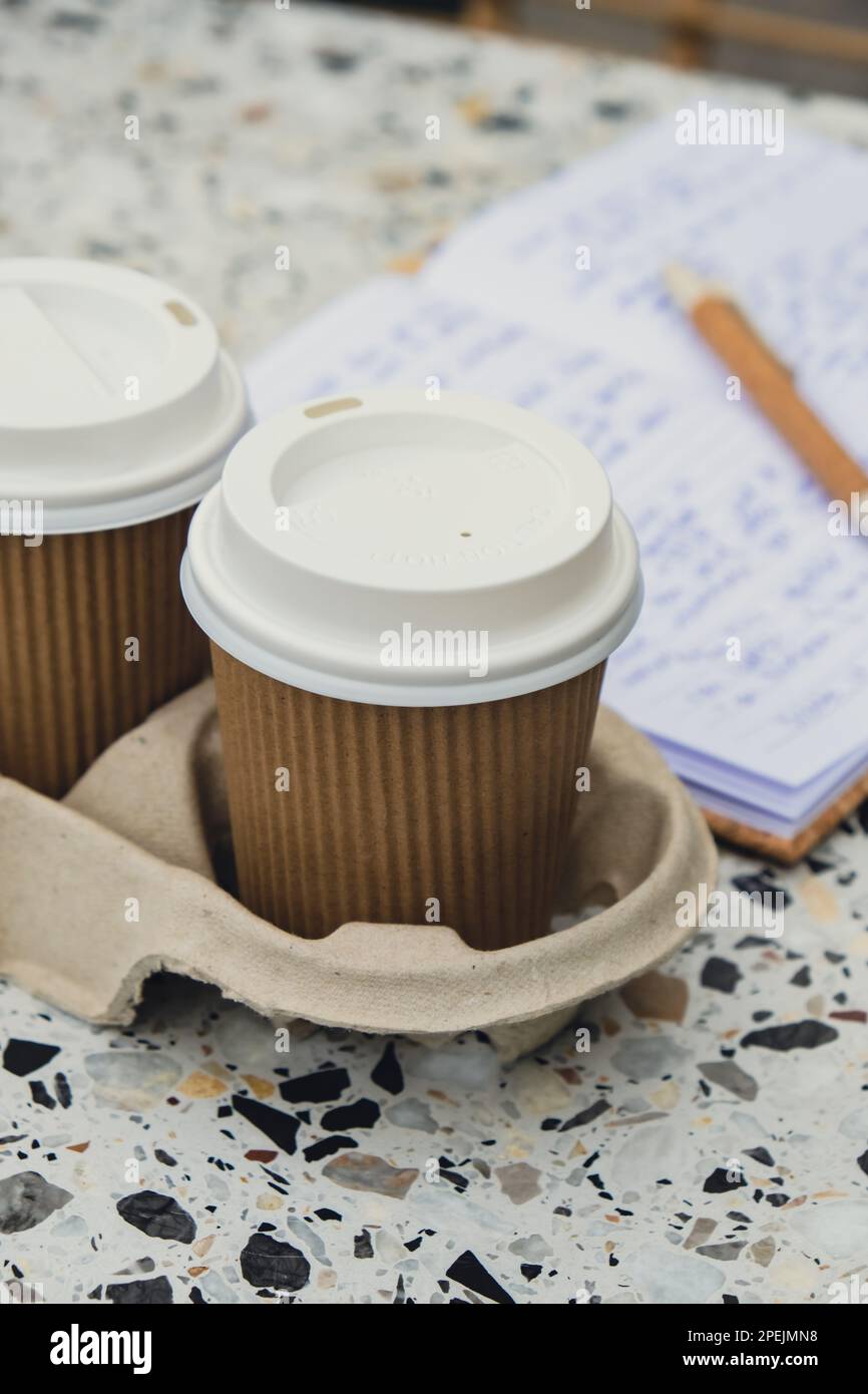 Two paper cups with lid for tea to go. Coffee take away on the table
