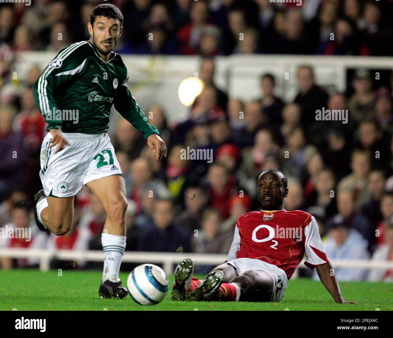 Pantelis Konstantinidis, left, from Panathinaikos races past a grounded Kolo Toure of Arsenal in the UEFA Champions League soccer match at Highbury Stadium, London, Tuesday Nov.2, 2004, between Arsenal FC and Panathinaikos
