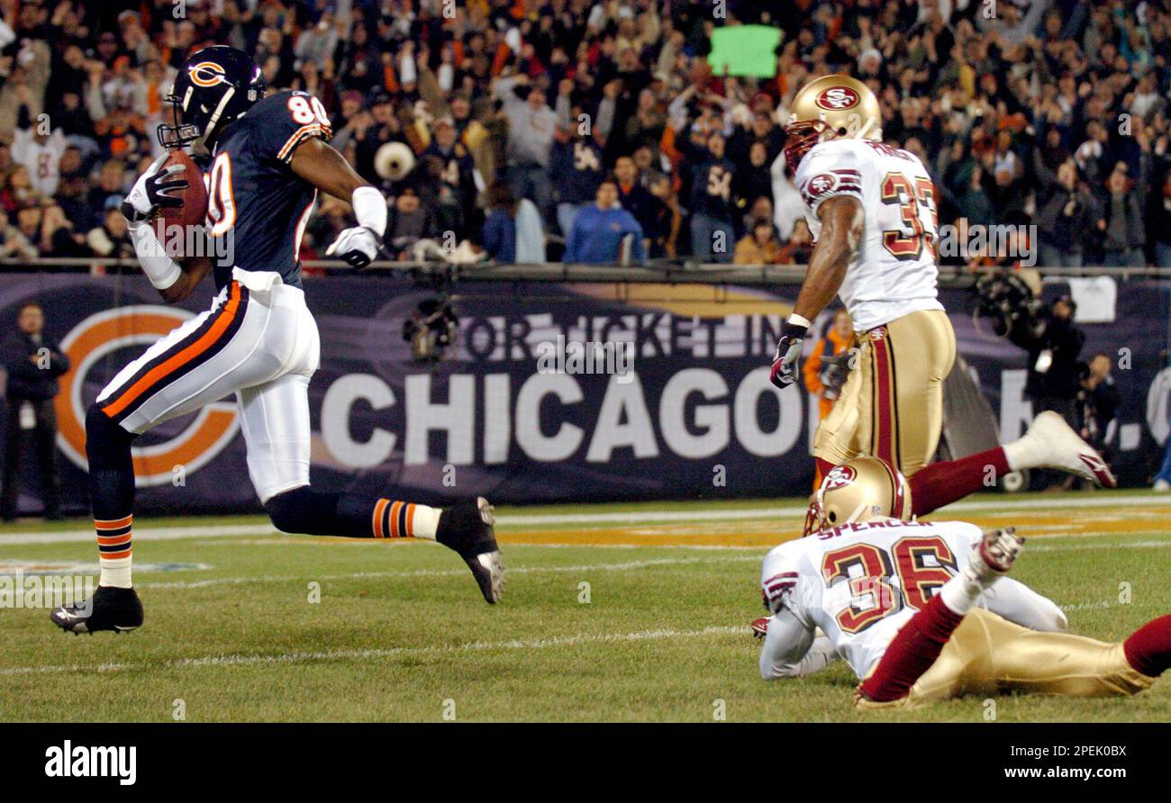 Chicago Bears receiver Bernard Berrian (80) runs past San Francisco 49ers  defenders Shawntae Spencer (36) and Tony Parrish (33) after catching a pass  for a 49-yard touchdown in the first quarter Sunday,