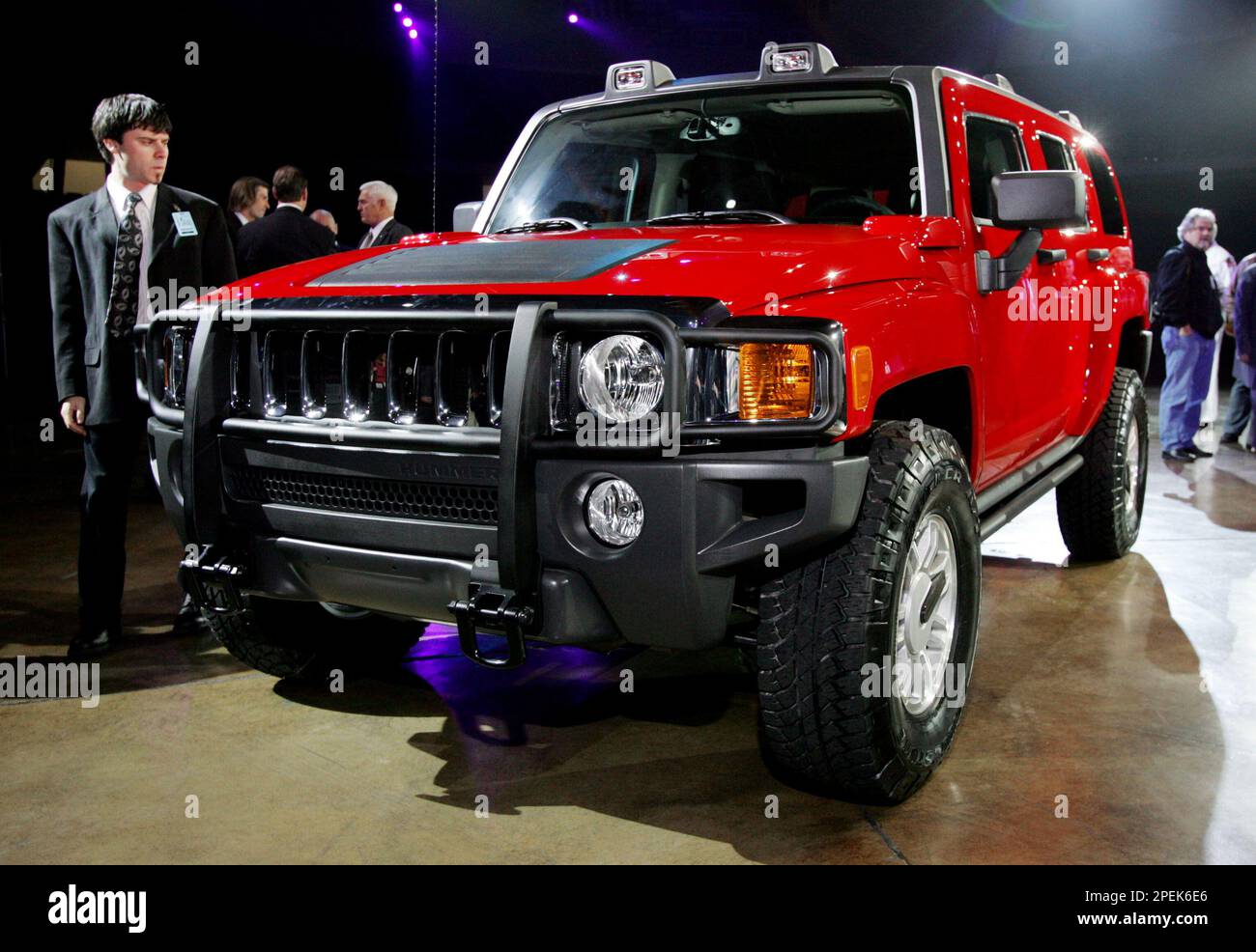 Members of the media and the automotive industry inspect the Hummer H3 sport utility vehicle during its introduction at the 2005 California International Auto Show at the Anaheim Convention Center in Anaheim, Calif., Wednesday, Oct. 27, 2004. The H3 is designed to be a smaller, more fuel-efficient vehicle than its H1 and H2 predecessors while maintaining the brand's off-road capabilities. The H3 will be built in a GM plant in Shreveport, La., and is scheduled to arrive at dealers in early- to mid-2005. (AP Photo/Reed Saxon) Stock Photo