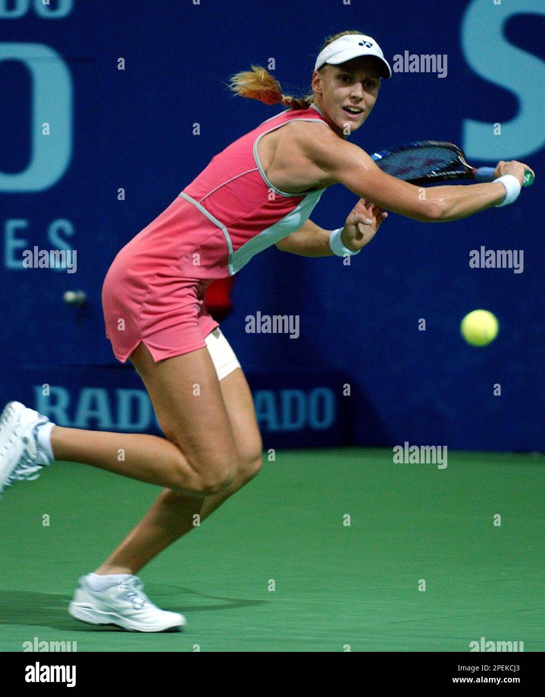 Jelena Dementieva of Russia returns the ball to Ai Sugiyama of Japan