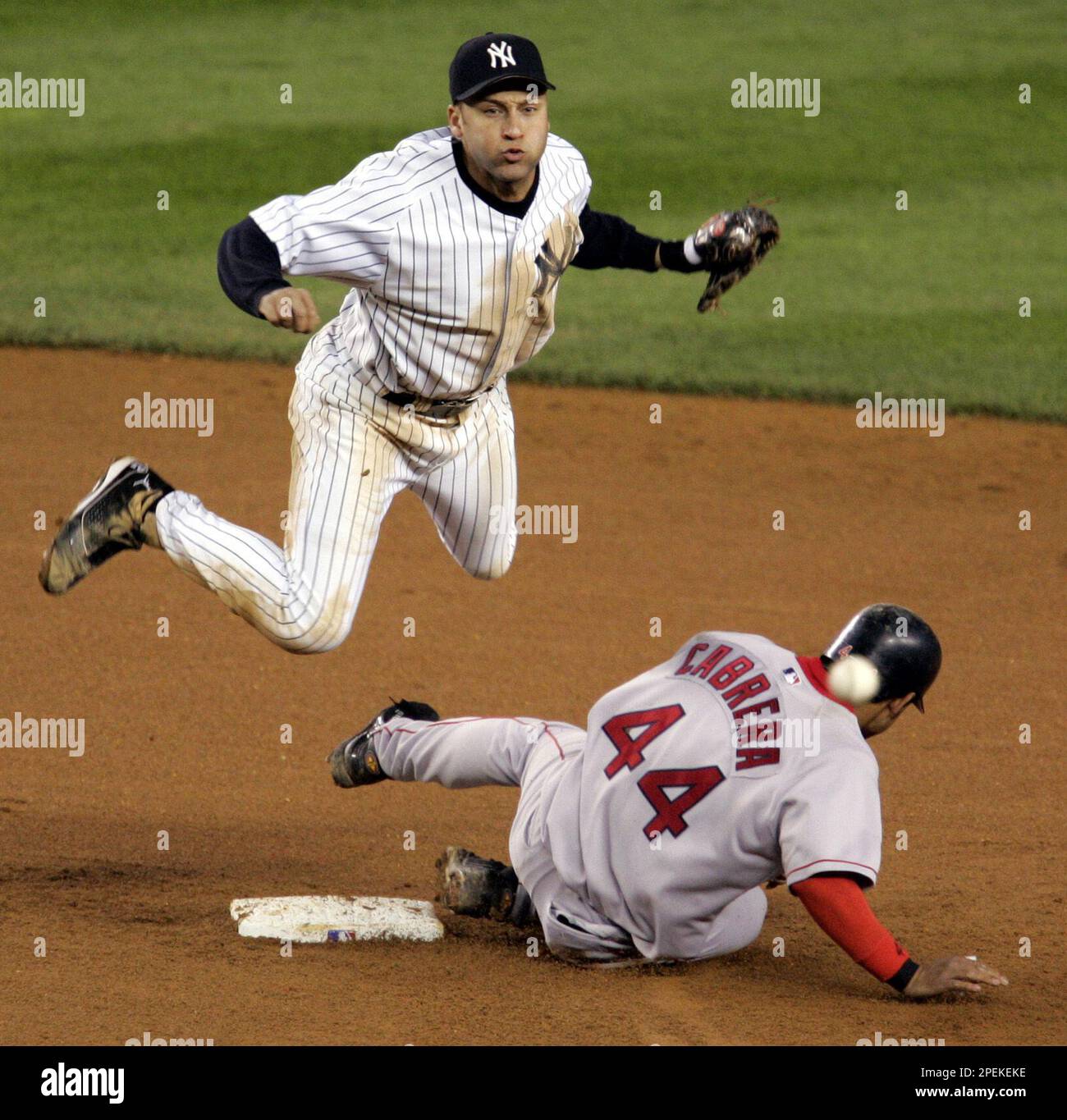 Boston Red Sox' Orlando Cabrera, right, becomes the first half of a double  play, as New York Yankees' Derek Jeter, left, completes the throw to first  in the seventh inning of game