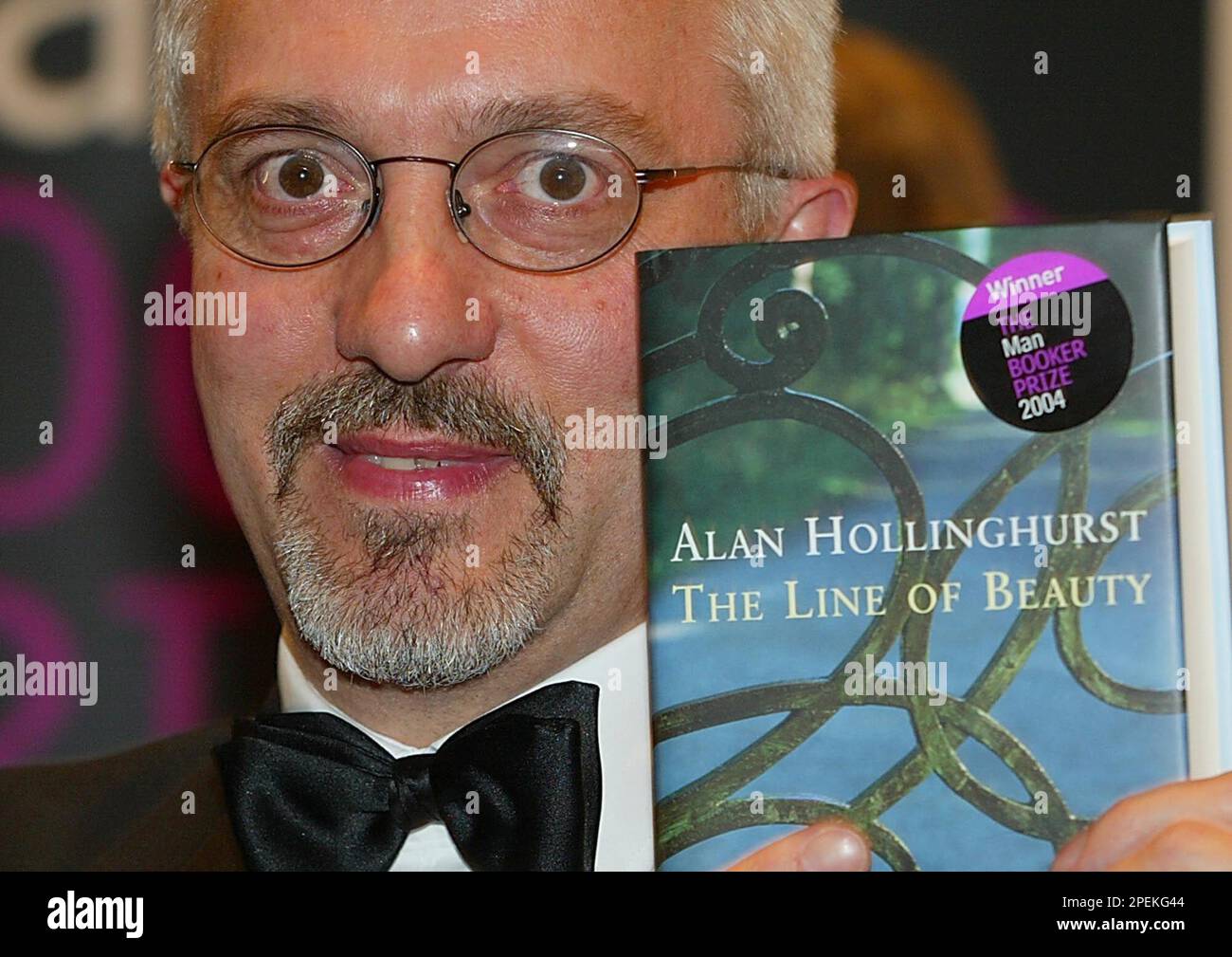 Alan Hollinghurst, winner of the 2004 Man Booker prize for fiction poses  for the cameras after the award in London late Tuesday Oct. 19, 2004.  Hollinghurst's book entitled 'The Line of Beauty'