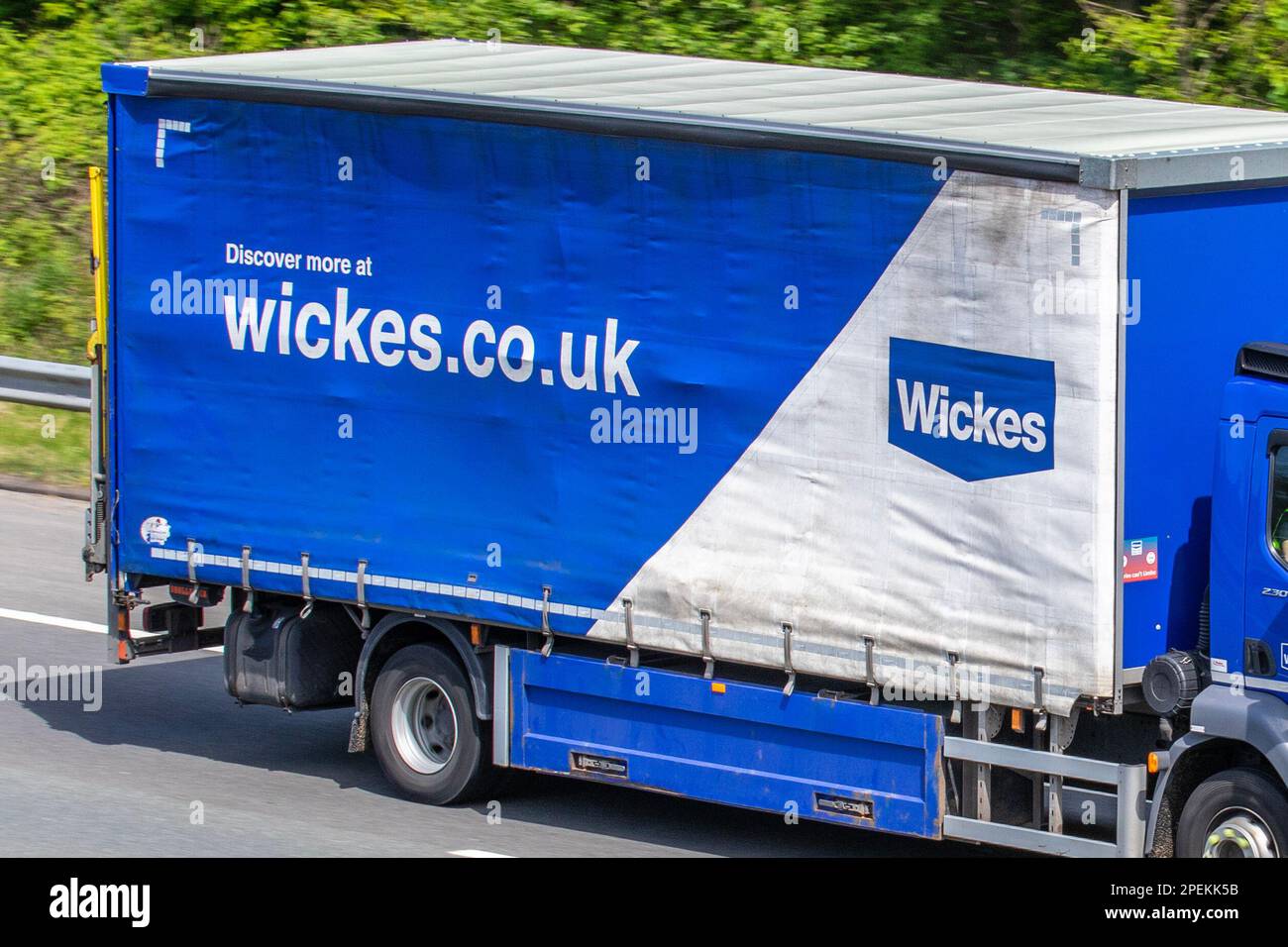 WICKES DIY, home improvement retailer. DAF LF curtainsided Lawrence David trailer travelling on