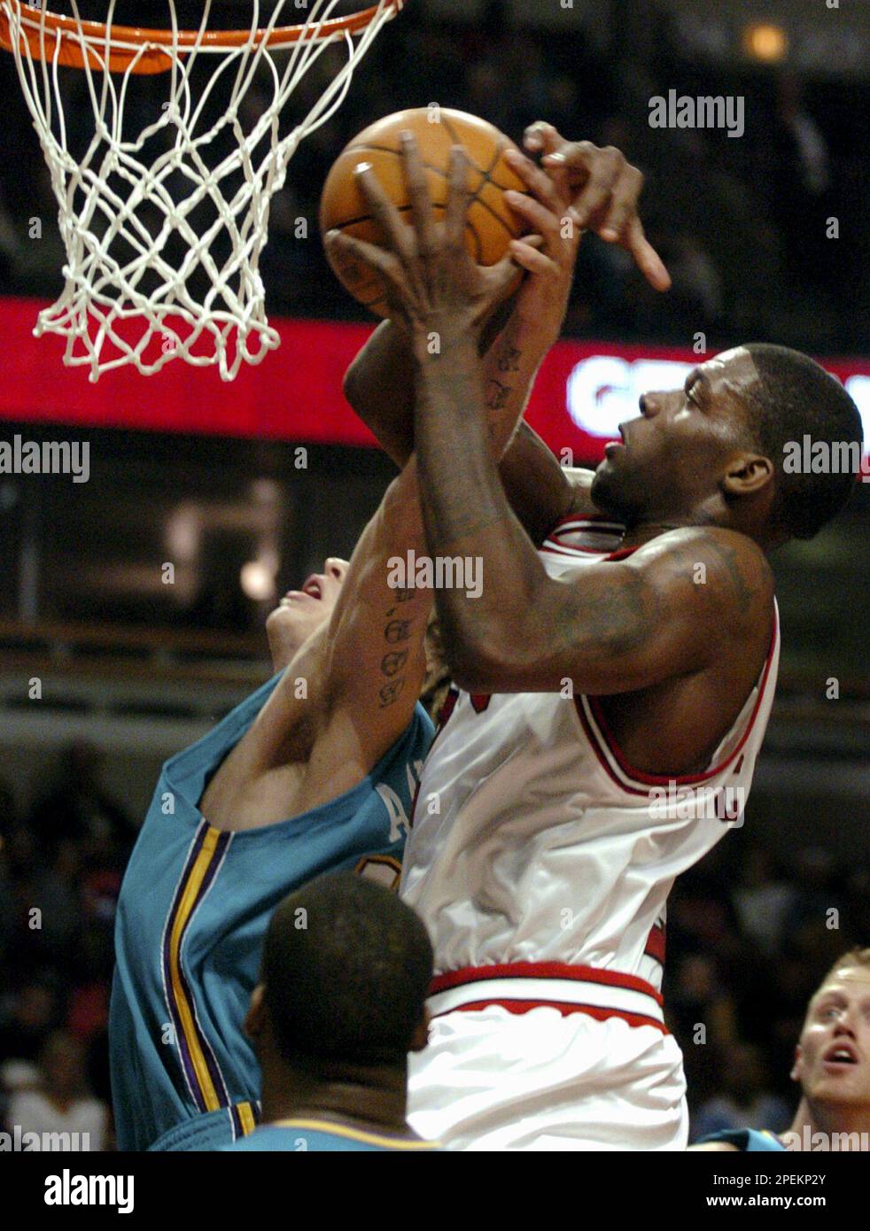 Chicago Bulls' Eddy Curry, right, tries to keep control of the ball against  New Orleans Hornets' Chris Anderson during the first quarter of a preseason  game Friday, Oct. 15, 2004, in Chicago. (