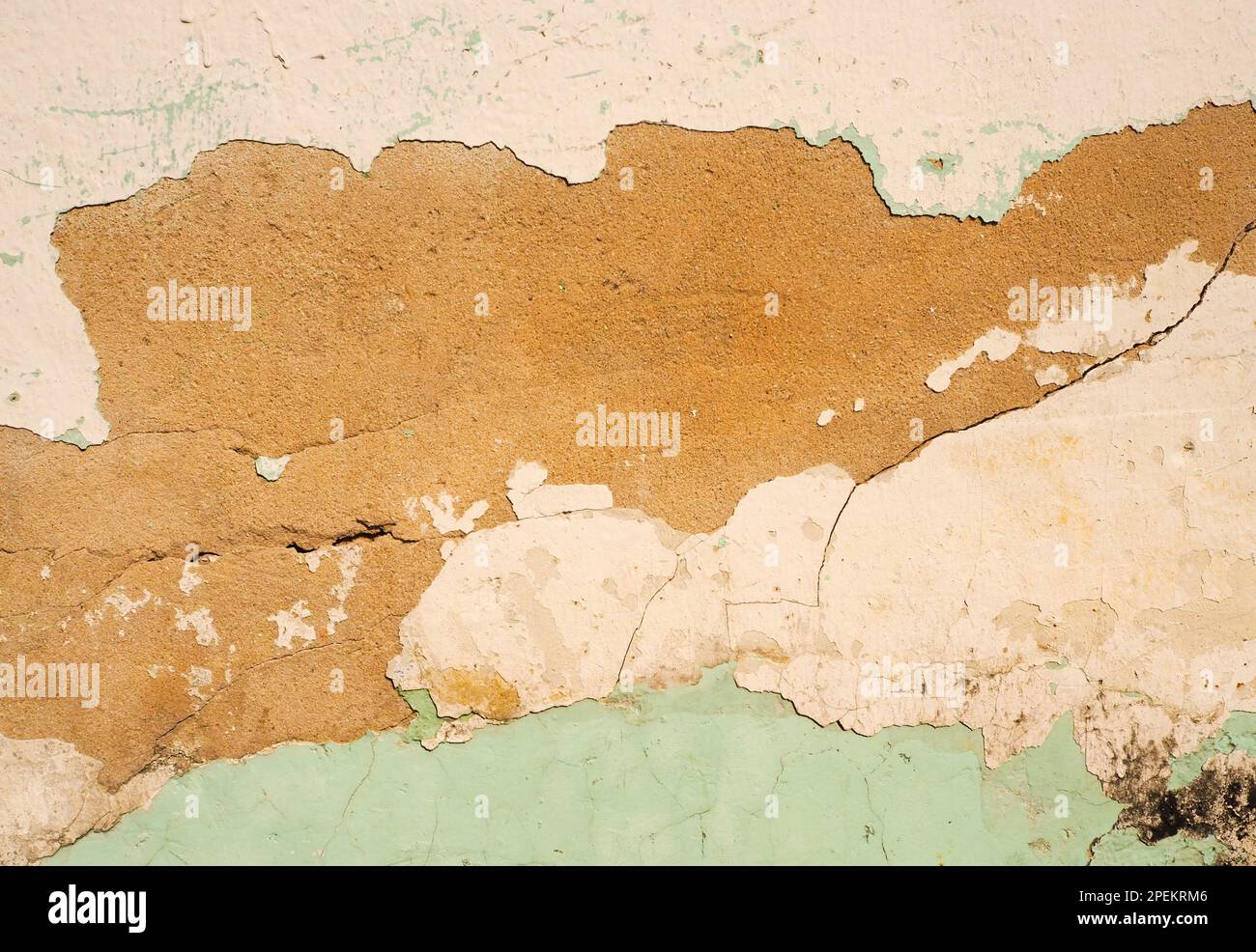 Wall texture of peeled off plaster and paint layers Stock Photo