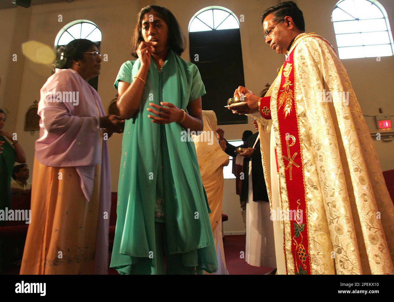 ** ADVANCE FOR THE WEEKEND OF OCT. 16 17 ** A parishioner receives communion from Rev. John