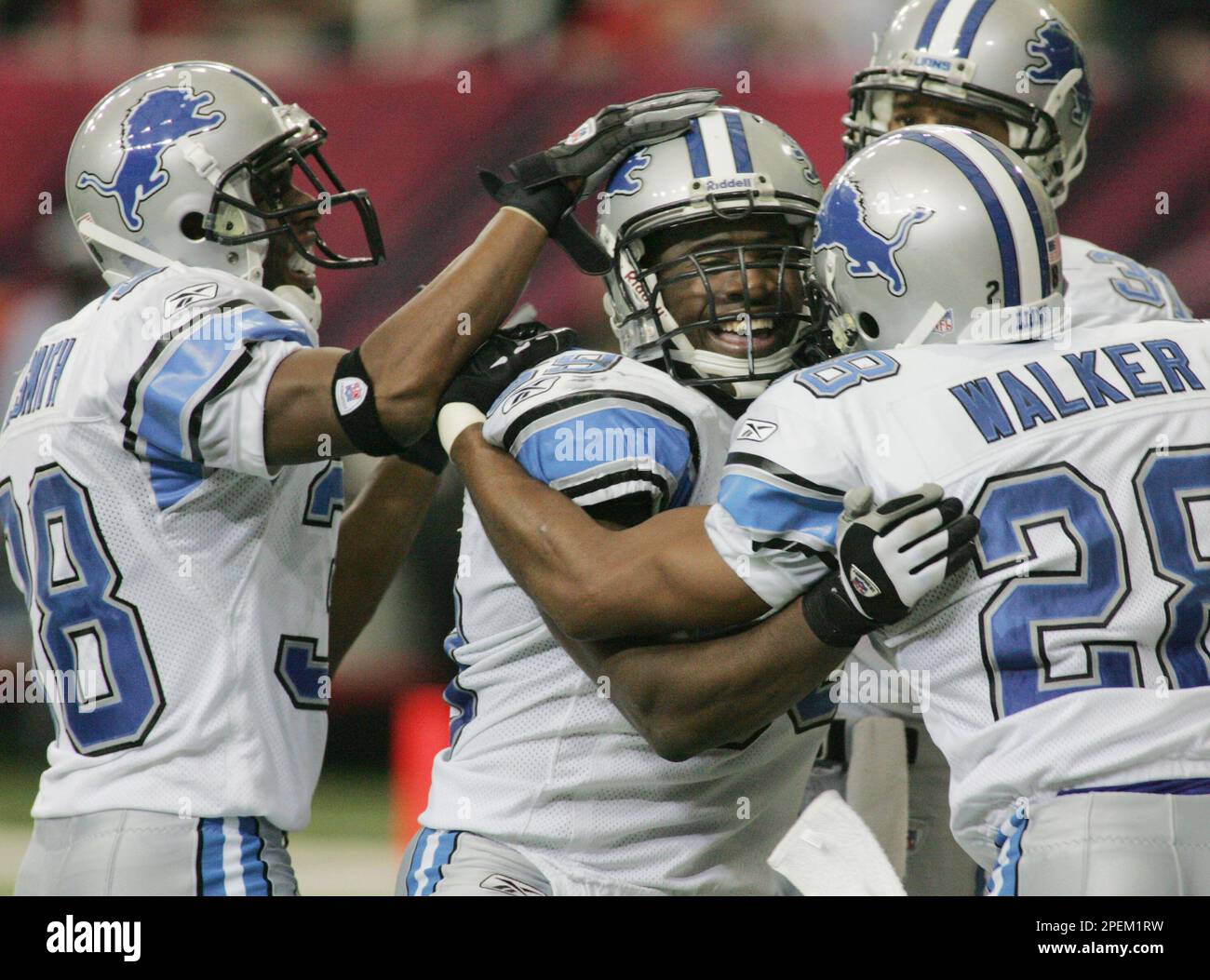 Detroit Lions linebacker Alex Lewis (59), center, celebrates