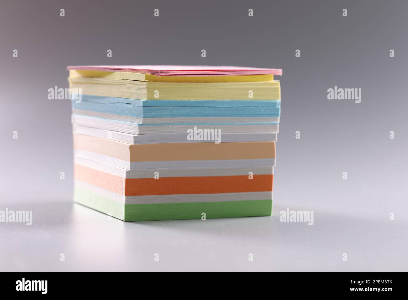 Stack of multicolored sticky notes on gray background Stock Photo