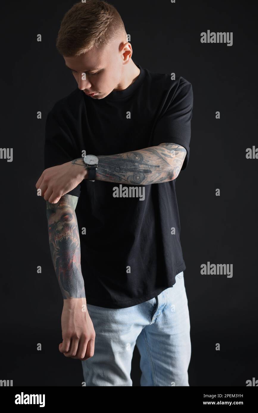 Young man with tattoos on arm hi-res stock photography and images - Alamy