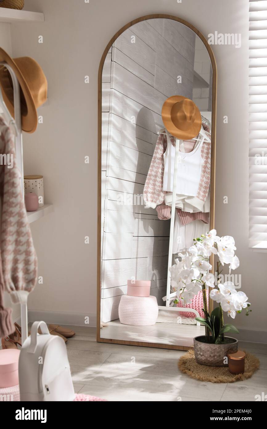 Big mirror, shoes and decorative elements in dressing room. Interior