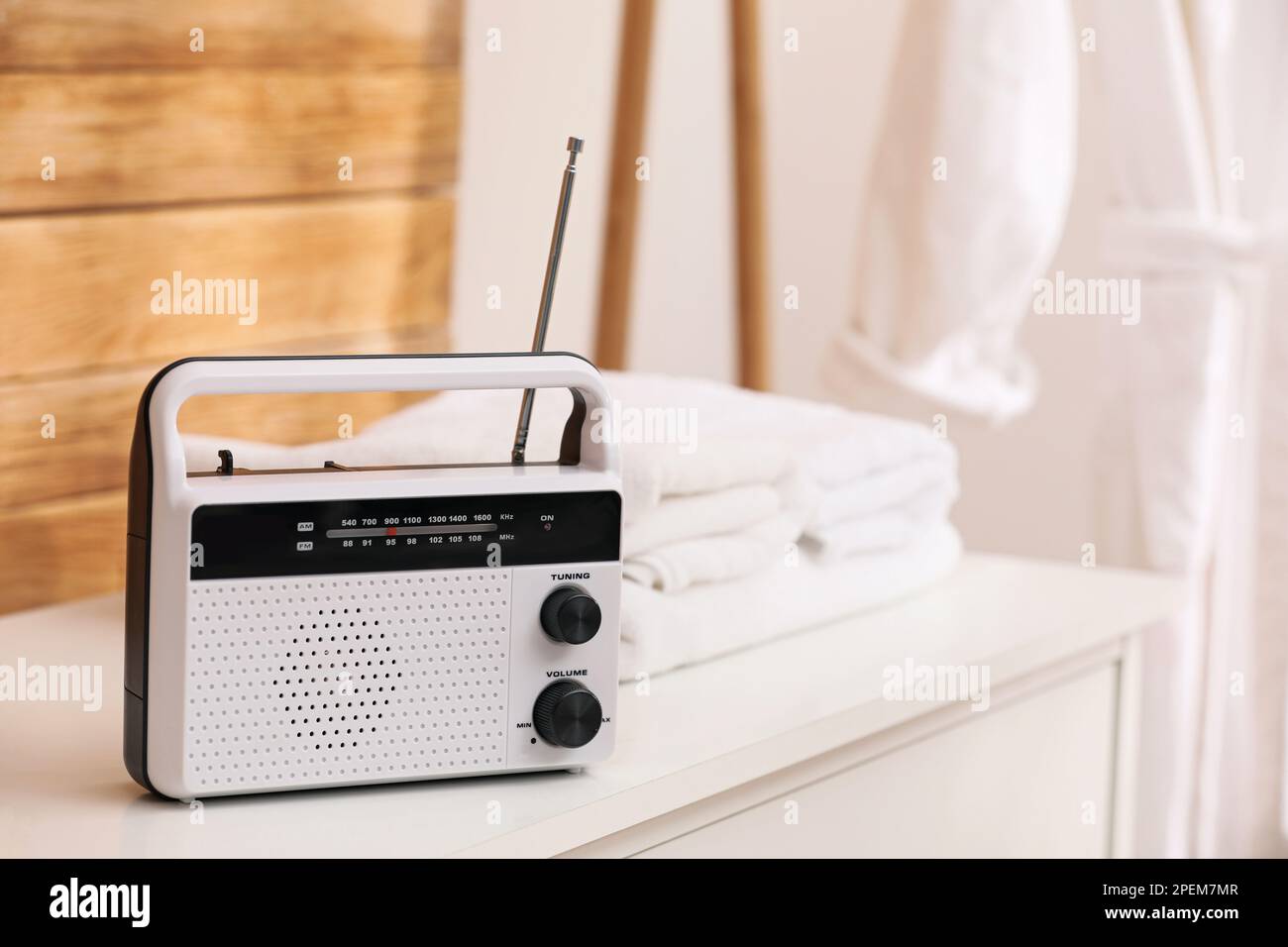 Stylish white radio on table in bathroom, space for text Stock Photo