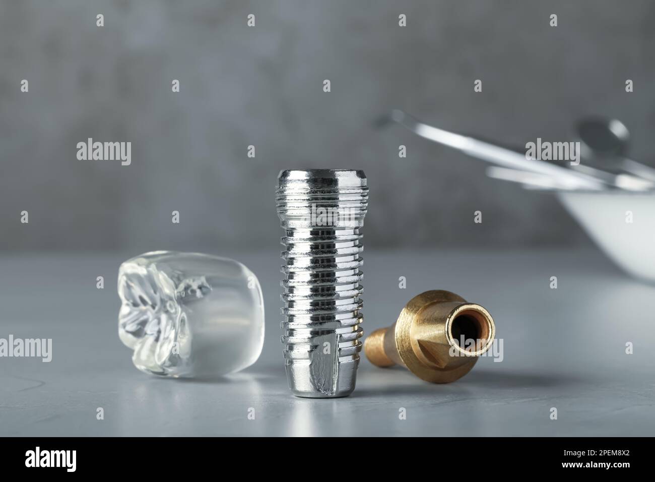 Parts of dental implant on grey table, closeup Stock Photo Alamy