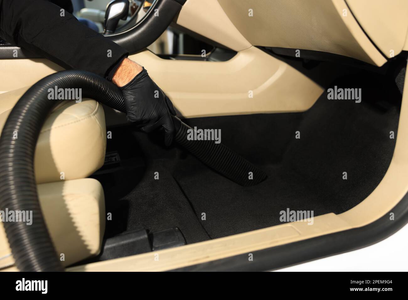 Man cleaning auto carpet with vacuum cleaner at car wash, closeup Stock Photo Alamy