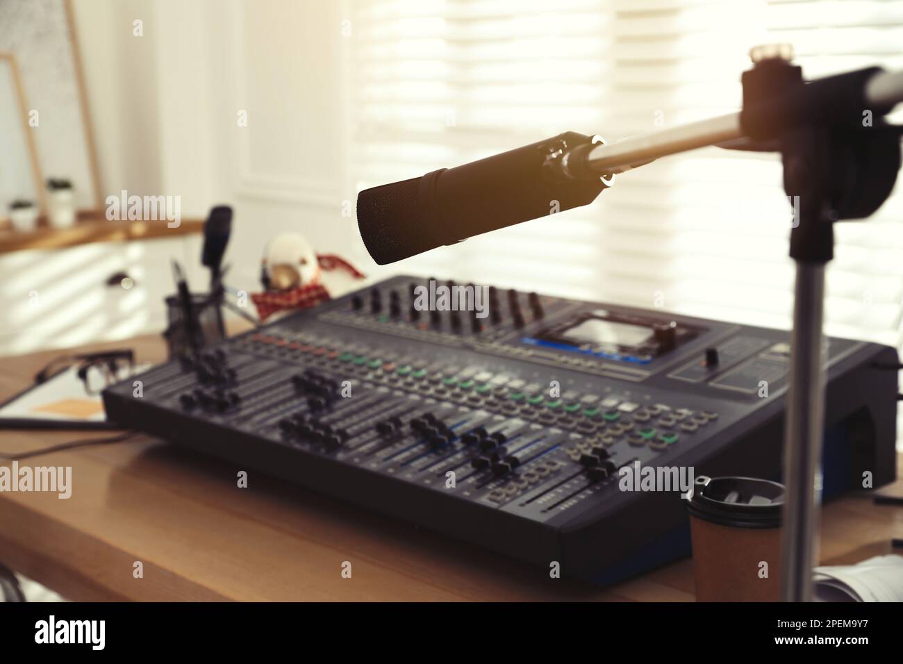 Microphone near professional mixing console in radio studio Stock Photo