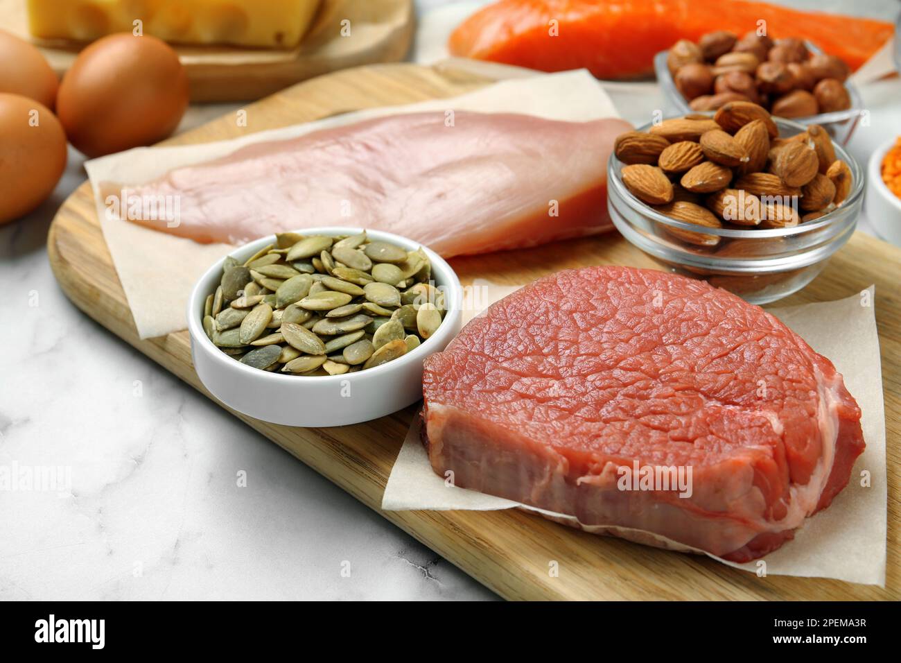 Fresh meat and other products on white table, closeup. Sources of