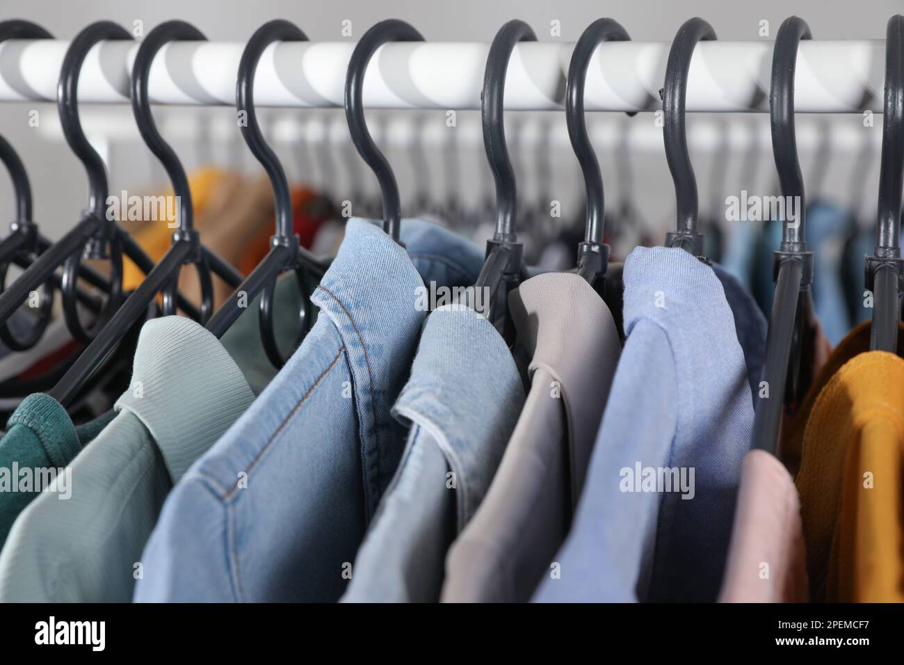 Close Up Of Colorful Tshirts On Hangers Apparel Background Stock