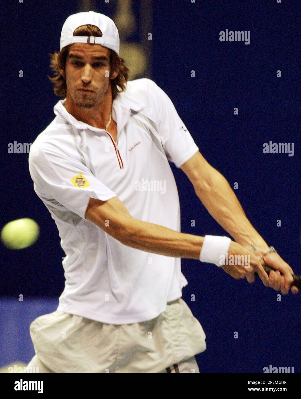 Flavio Saretta of Brazil hits a backhand to Marat Safin of Russia
