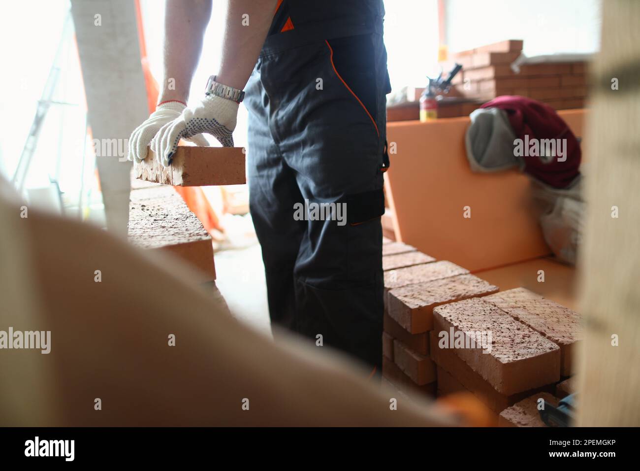 Bricklayer or mason laying bricks to build wall Stock Photo Alamy