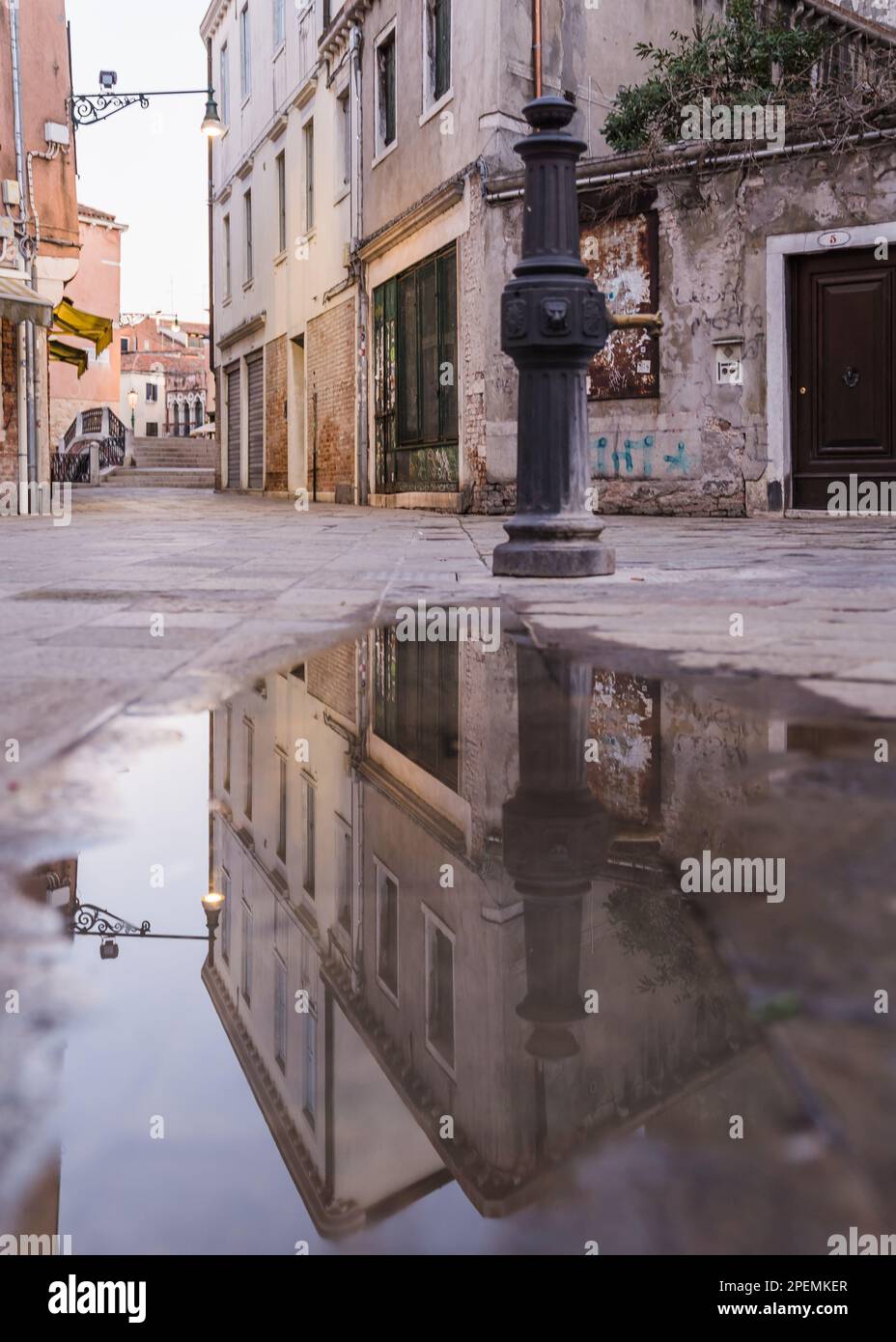 Water fountain and puddle of water in Venice, Italy Stock Photo - Alamy