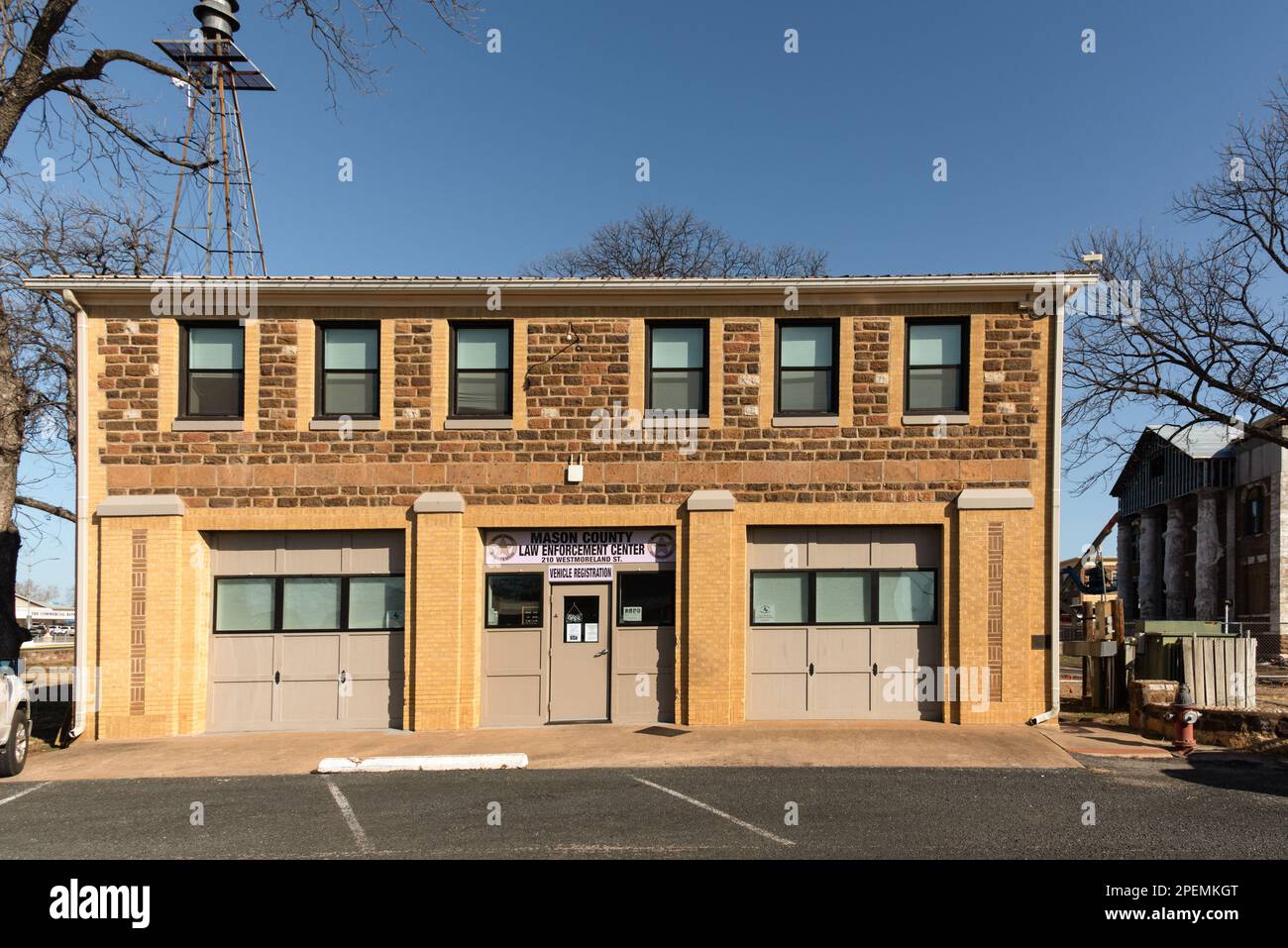 A vintage two story building housing the Mason County Law Enforcement Center and Vehicle Registration in downtown Mason, Texas, USA. Stock Photo