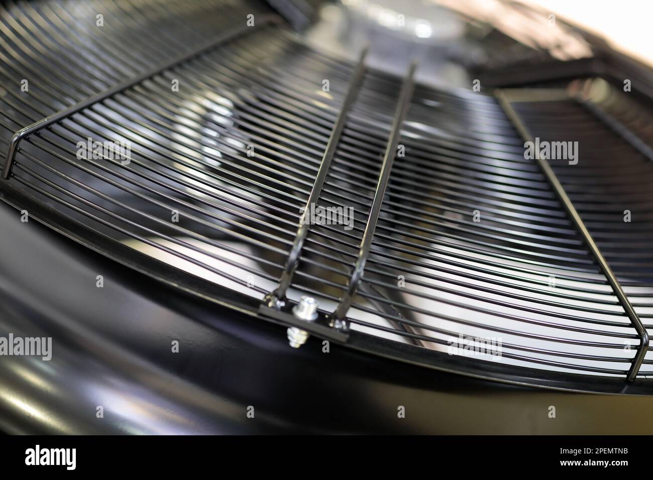 Metal wire guard cover grill of industrial fan closeup. Selective focus