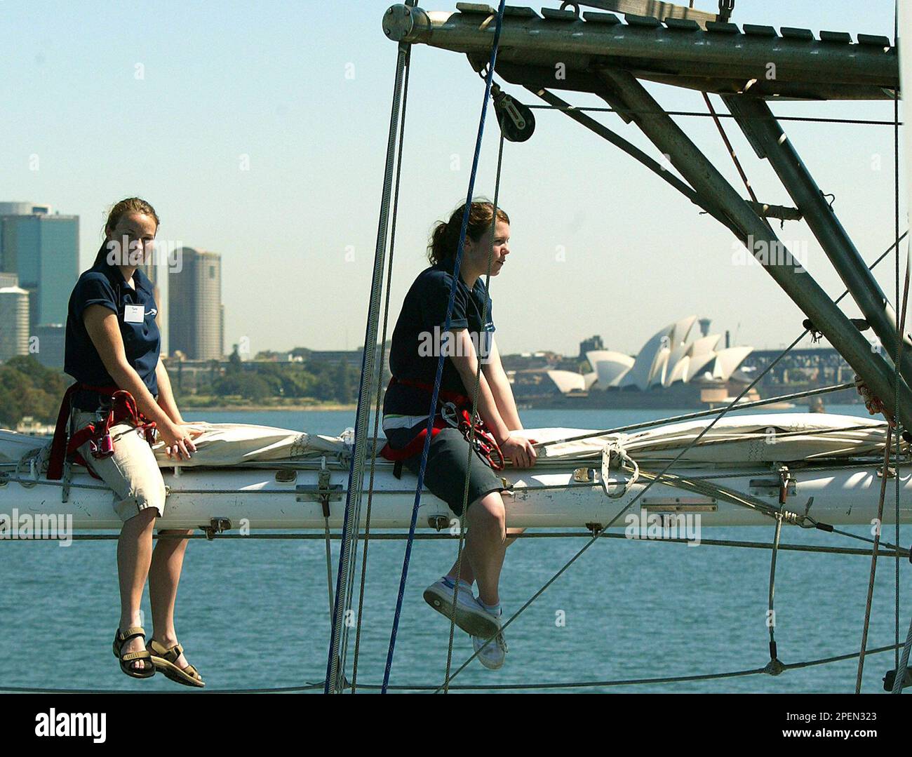 Two volunteer crewmen onboard the tall ship Young Endeavour, secure a