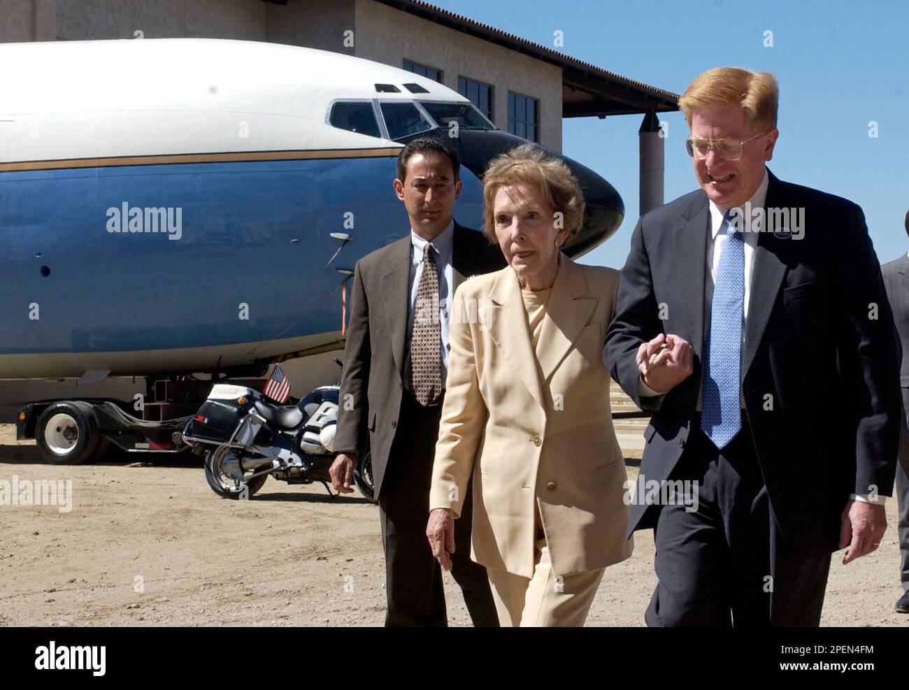 Former first lady Nancy Reagan is escorted by Rudy F. deLeon as the ...