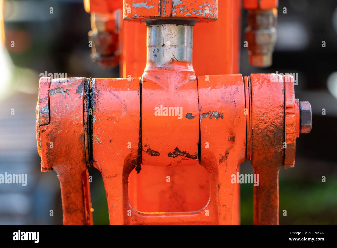 Closeup of a rusty hydraulic assembly on an excavator or other machine