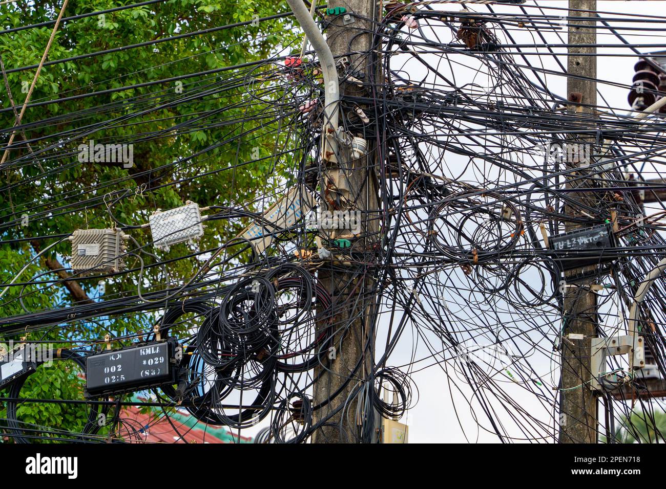 Tangled electrical wires in Thailand. Problems with flooding during tropical downpours. Stock Photo