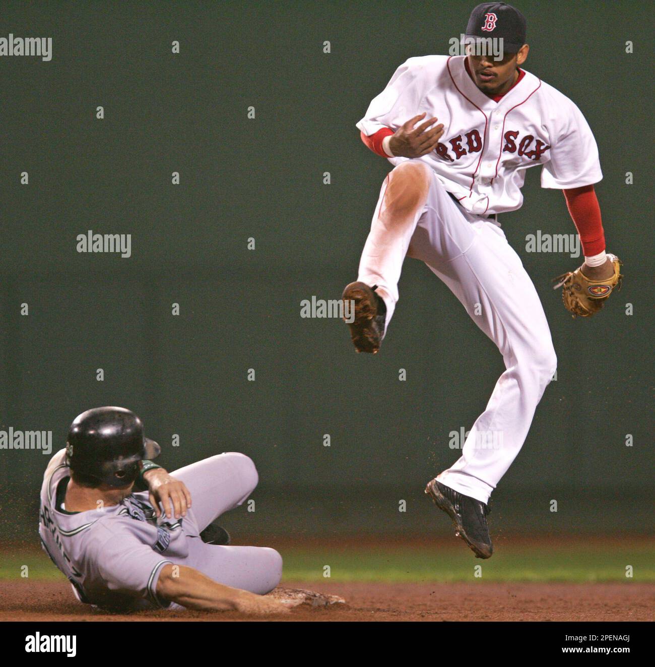 Boston Red Sox shortstop Orlando Cabrera, right, leaps after