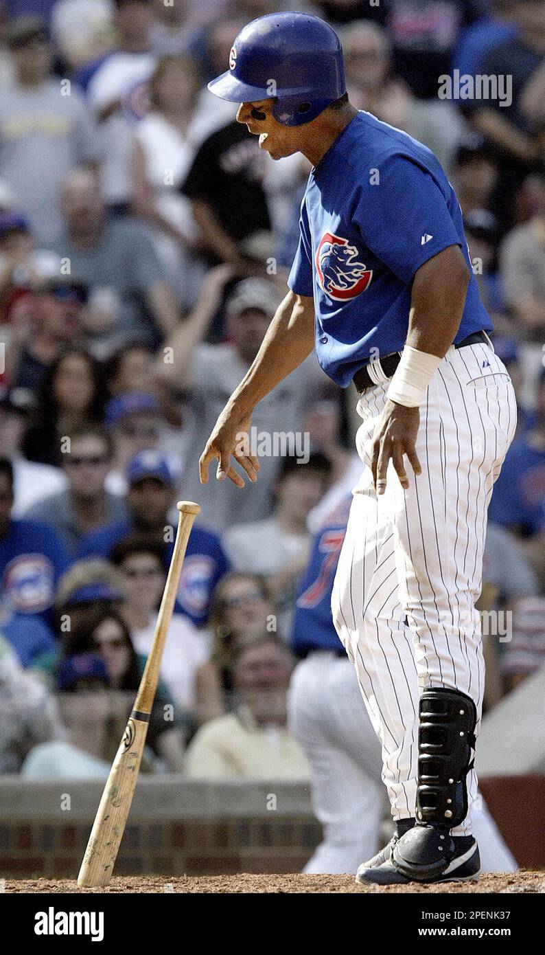 Chicago Cubs' Moises Alou tosses his bat after striking out against Florida  Marlins in the seventh inning Saturday, Sep 11, 2004, in Chicago. The Cubs  won 5-2.(AP Photo/ Nam Y. Huh Stock