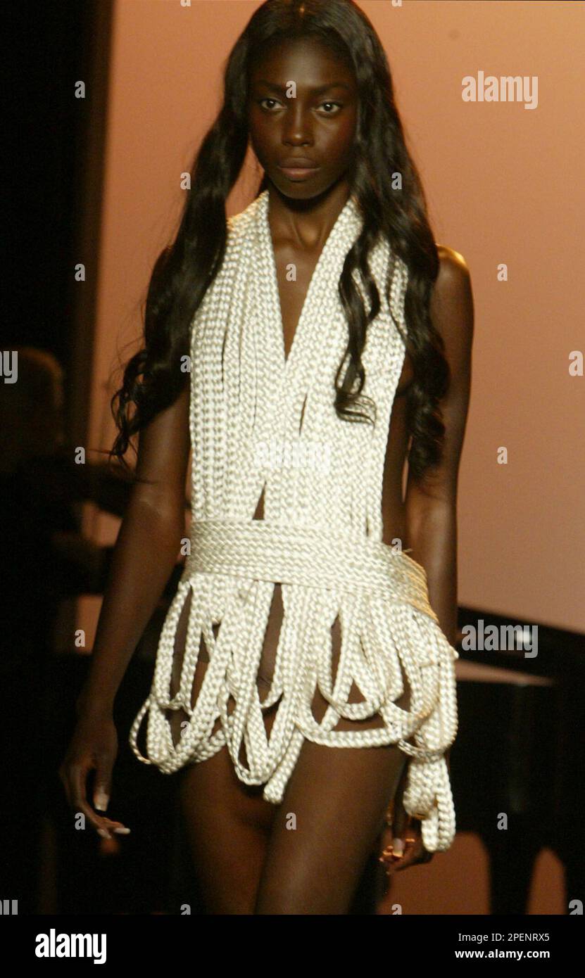Loops of nylon rope are draped together for a dress being modeled during  the showing of