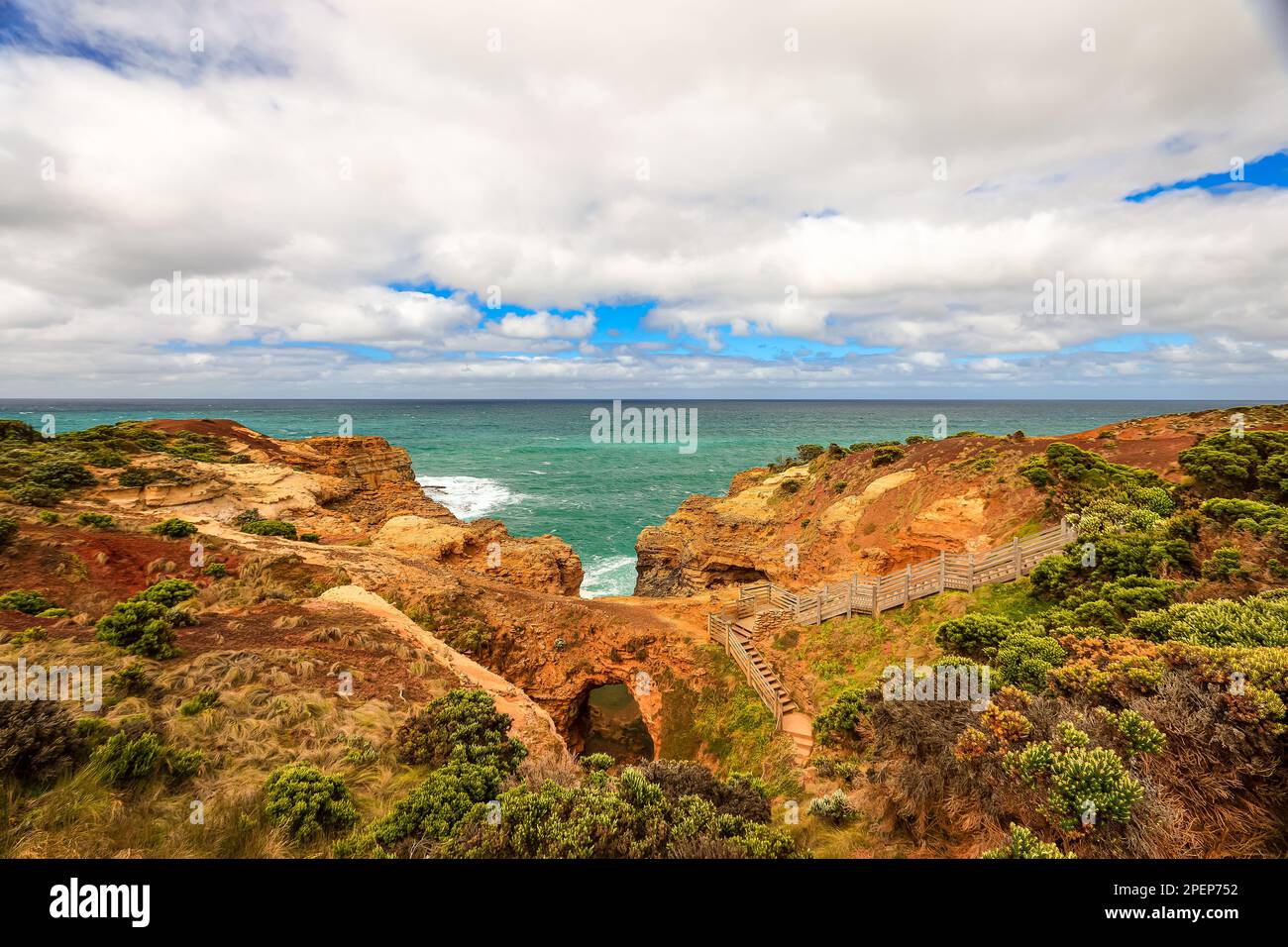 Landscape in Port Campbell National Park, Victoria Australia with footpath over wooden steps and landings to the Grotto a sinkhole with eroded view to Stock Photo