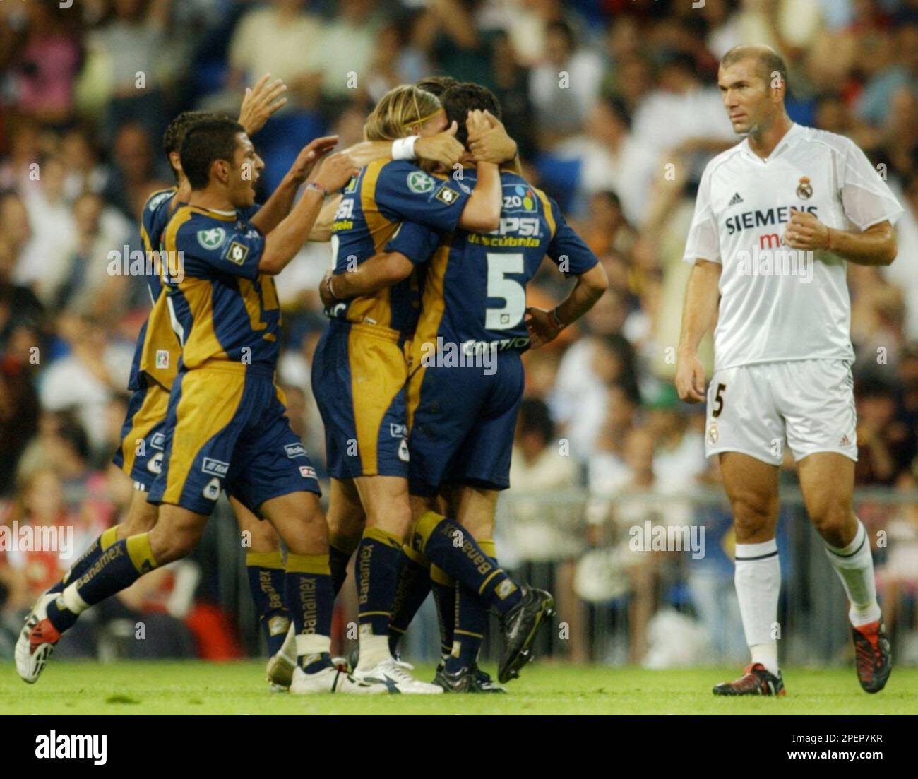 Mexican team Pumas players celebrate beside Real Madrid's French player  Zinedine Zidane after scoring a goal during a friendly soccer match in  Real's Santiago Bernabeu stadium in Madrid Tuesday Aug. 31, 2004. (