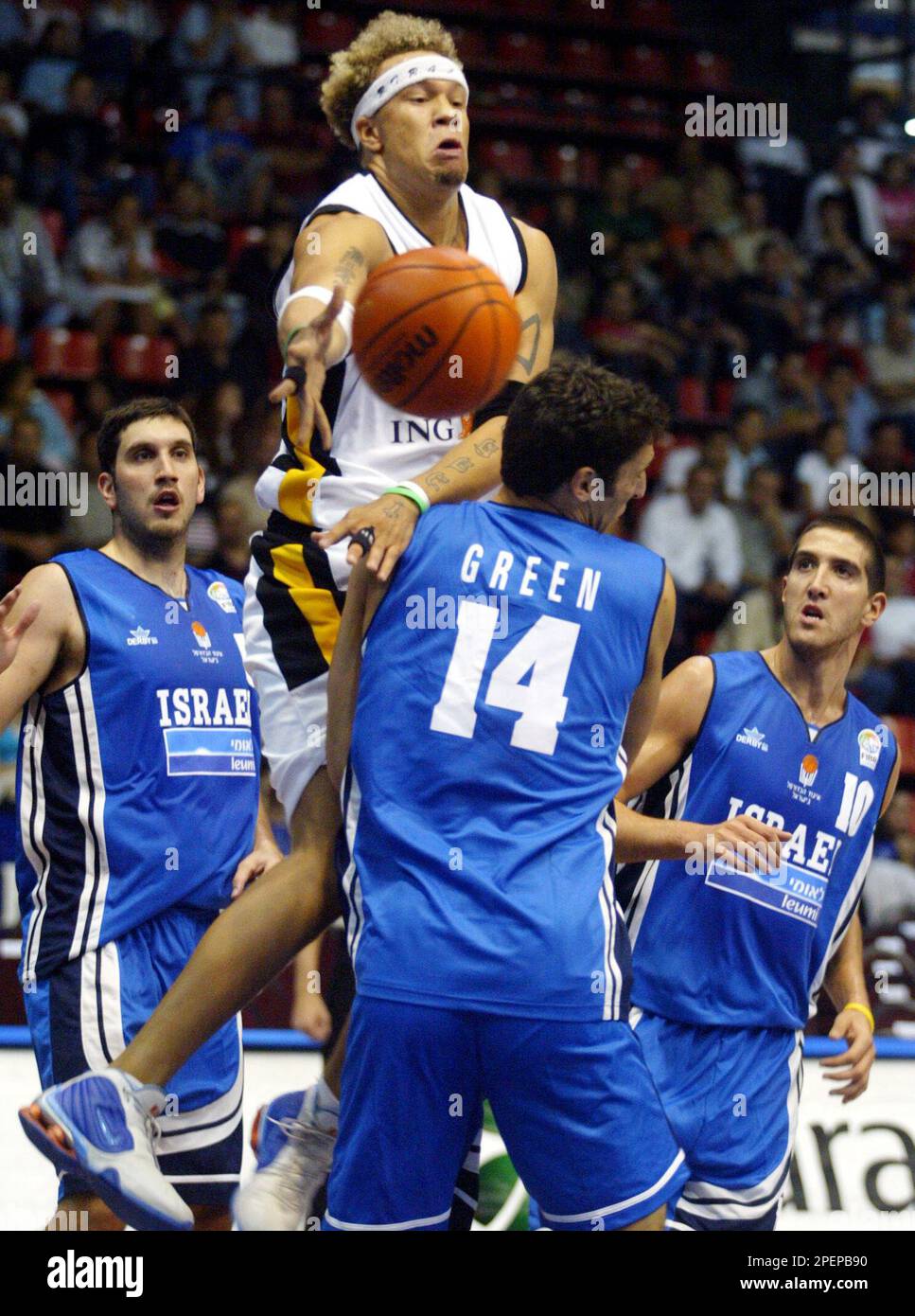 Misan Nikagbatse, center, of Germany, goes for basket as Yaniv Green of  Israel blocks during the Efes Pilsen Istanbul World Cup 3 basketball  tournament in Istanbul, Turkey, Sunday Aug. 29, 2004.(AP Photo/Osman