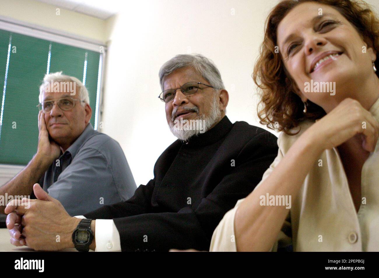 Arun Ghandi, the grandson of Mohandas Gandhi, center, sits next to Knesset  Members Haim Oron, left, and Yuli Tamir, right, prior to a meeting with the  initiators of the Geneva Accord, an