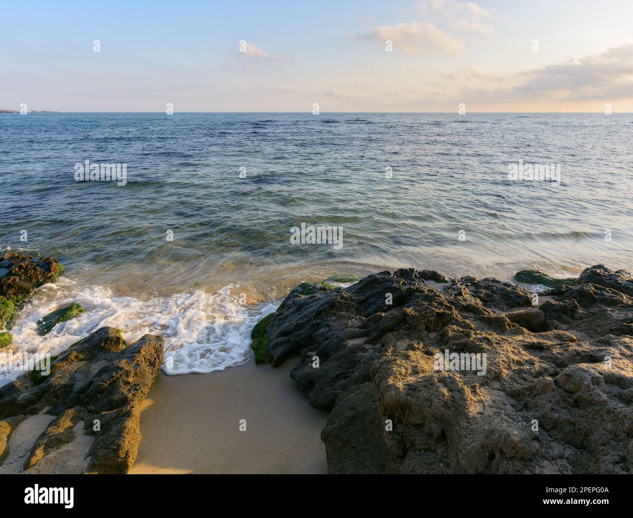wave washing the sandy beach with stones. summer holiday season and recreation at the sea concept Stock Photo