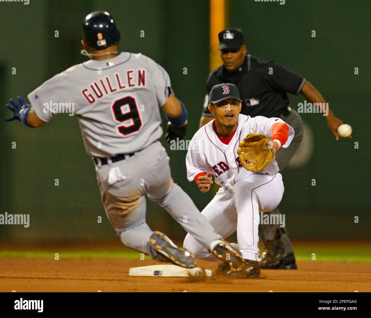Boston Red Sox shortstop Orlando Cabrera awaits the throw from right  fielder Dave Roberts to get Detroit Tigers' Carlos Guillen trying to  stretch a single into a double during the fourth inning