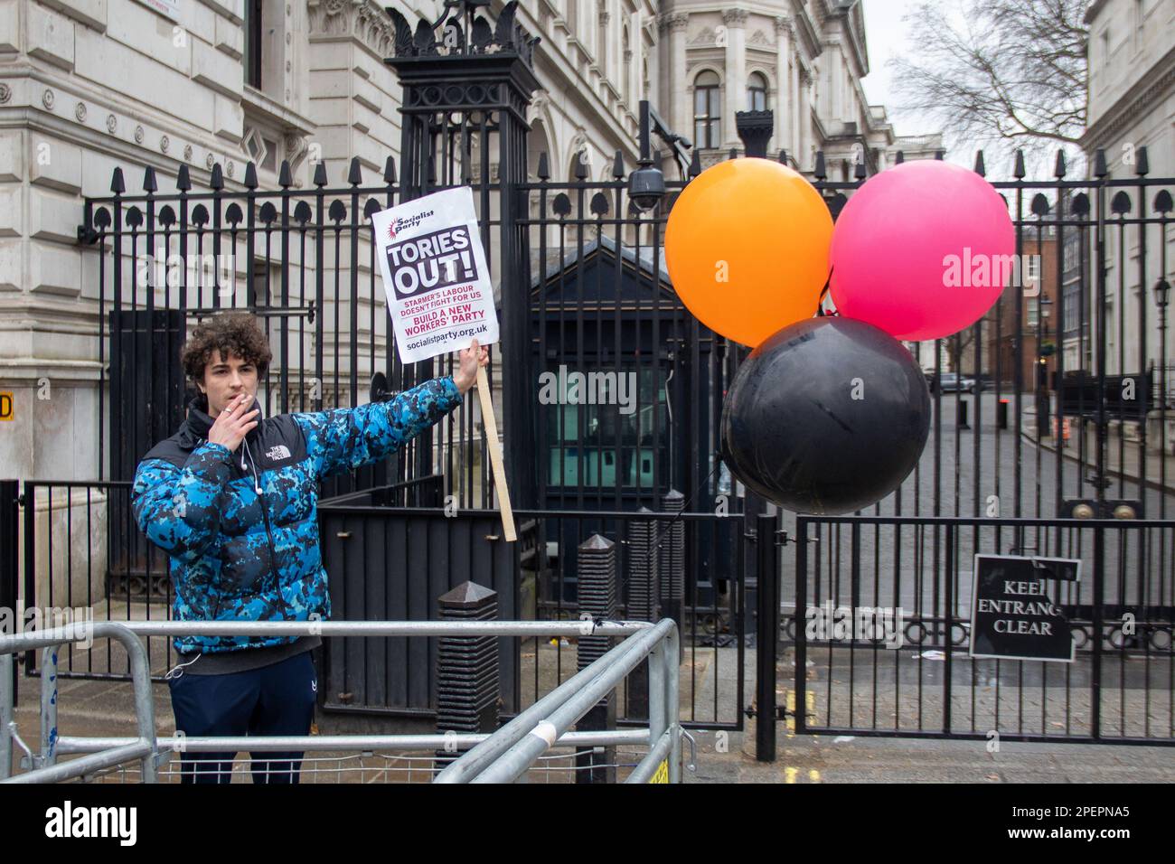 London, UK. 15th Mar, 2023. London, UK - March 15, 2023: On Budget Day, amid a 24-hour general strike involving numerous unions and workers, a socialist protester stood in front of Downing Street. Credit: Sinai Noor/Alamy Live News Stock Photo
