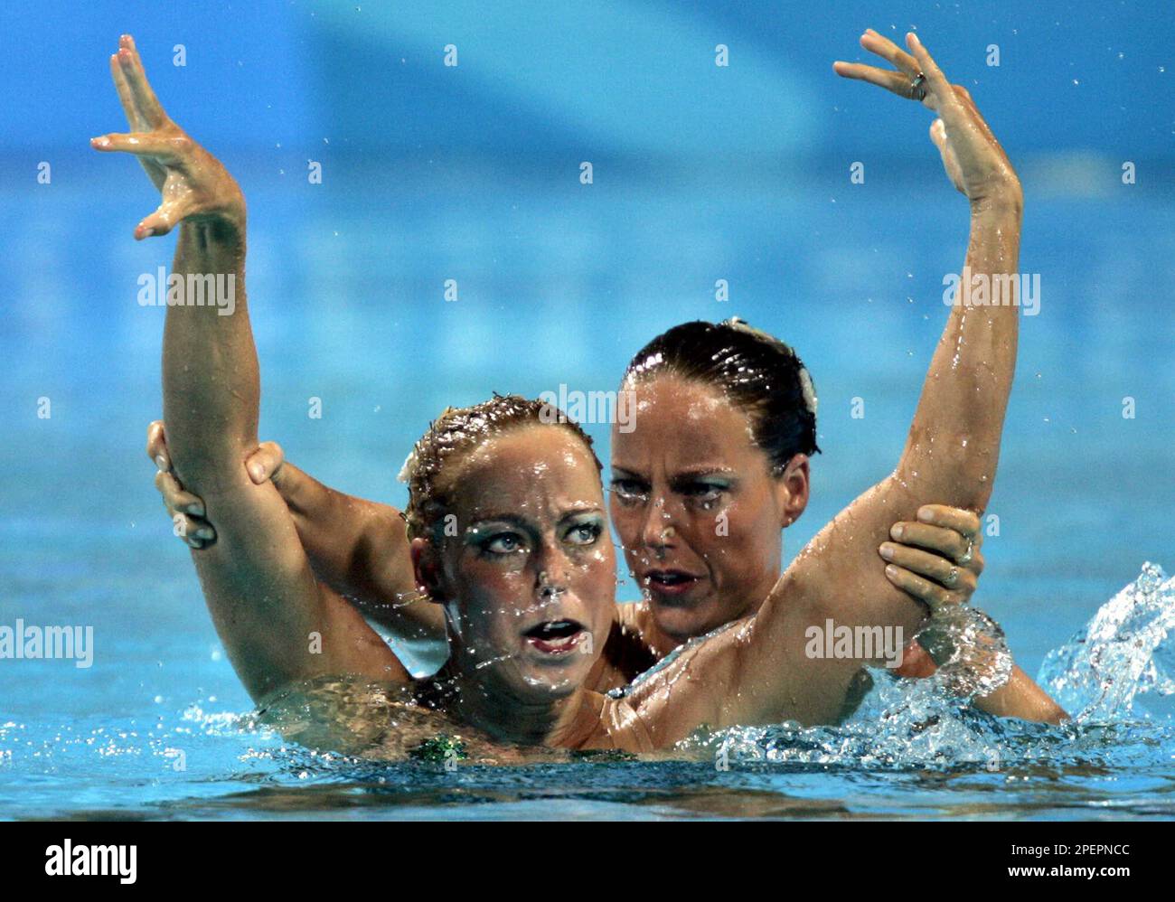 Twins Bianca and Sonja Van Der Velden of the Netherlands perform in the duet techical routine preliminary in synchronized swimming, in the Olympic Aquatic Center at the 2004 Olympic Games in Athens,