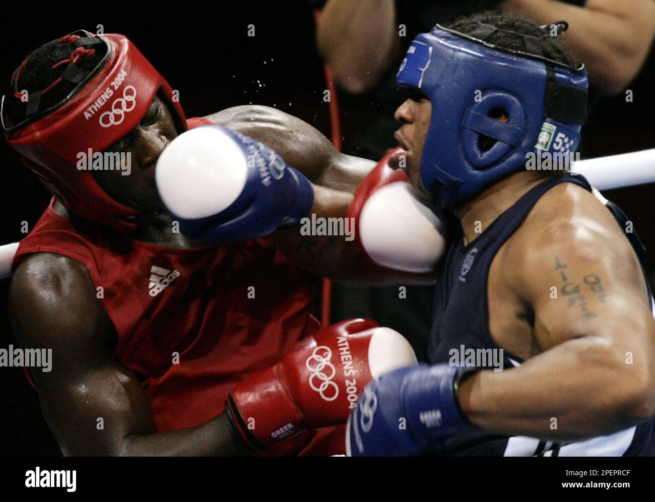 American Jason Esgtrada, right, from Providence, R.I., lands his right on  Cuba's Michel Lopez Nunez during the super heavyweight boxing quarterfinals  in the 2004 Athens Summer Olympic Games at the Peristeri boxing