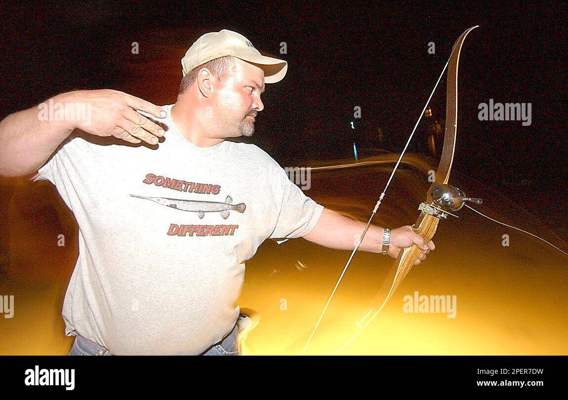 https://c8.alamy.com/comp/2PER7DW/jason-meyer-shoots-an-arrow-which-is-attached-to-the-bow-with-a-heavy-line-and-a-reel-while-bowfishing-may-16-2004-on-tainter-lake-near-menomonie-wis-meyer-of-rural-eau-claire-likes-to-bowfish-at-night-because-this-is-when-carp-and-other-rough-fish-are-more-likely-to-be-prowling-in-shallow-water-ap-photoeau-claire-leader-telegram-shane-opatz-2PER7DW.jpg