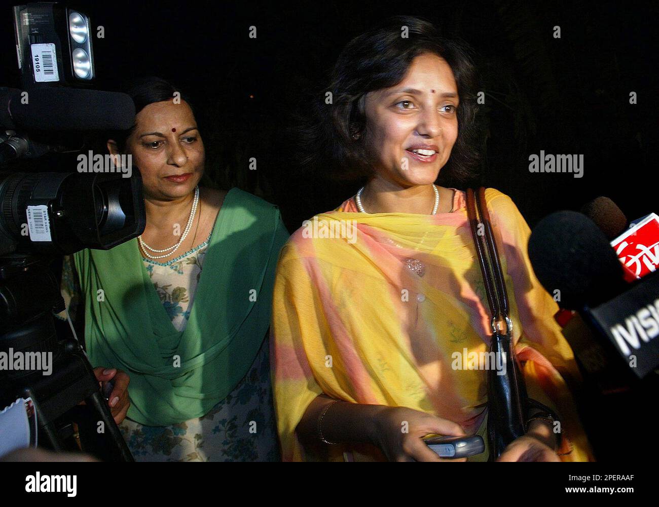 Gayatri Rathore, right, wife of Athens Olympics silver medallist Rajyavardhan Singh Rathore speaks to the media as mother Manju Rathore, left, looks on at Rajyavardhan Singh Rathores residence in New Delhi, India, Tuesday, Aug. 17, 2004. India exulted Tuesday after shooter Rajyavardhan Singh Rathore won the first individual Olympics silver medal, a rare feat in this billion strong nation where athletes complain that nothing apart from cricket, the national passion, gets attention. (AP Photo/Gurinder Osan) Stock Photo