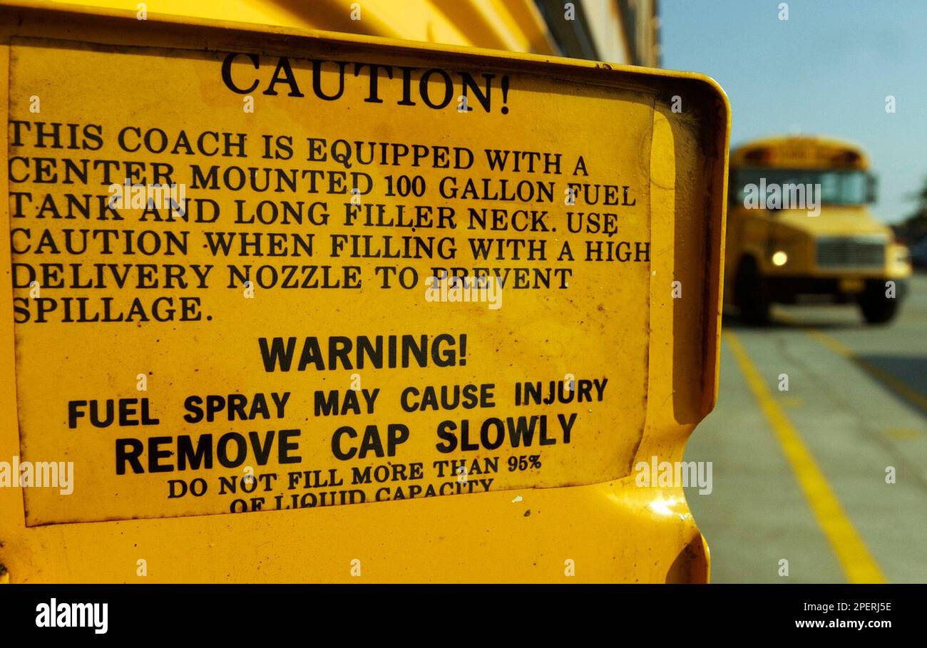 ADVANCE FOR MONDAY AUG. 17 ** A caution sign on the gas door of a school bus  mentions the bus' 100 gallon fuel tank, Friday, Aug. 6, 2004 in Montgomery,  Ala., image size:1300x909