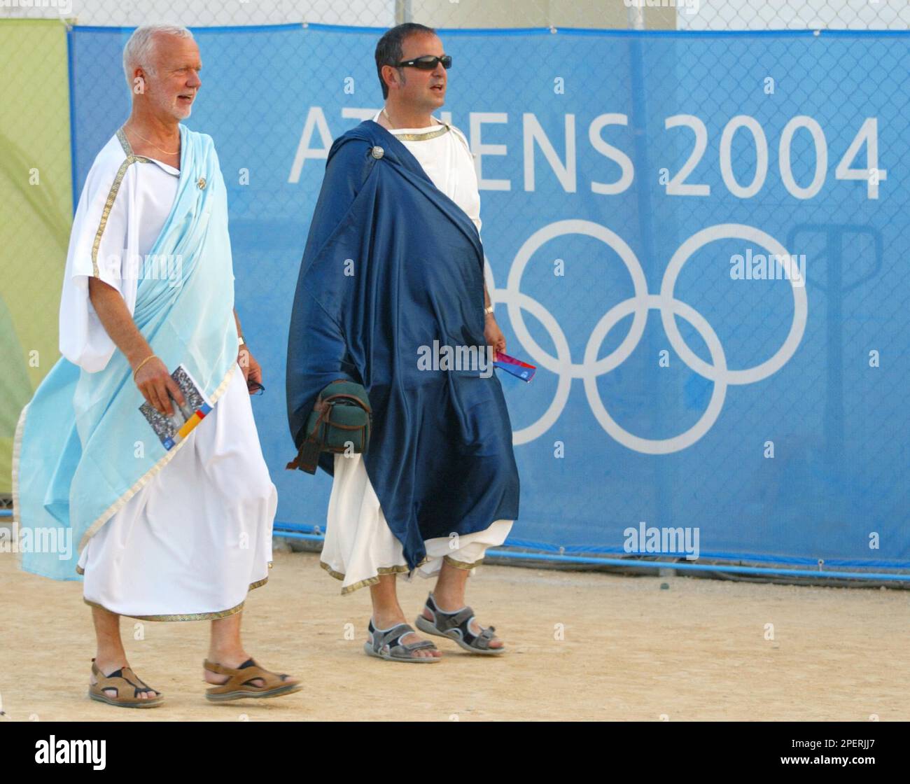 Two men make their way to their seats for the opening ceremonies of the