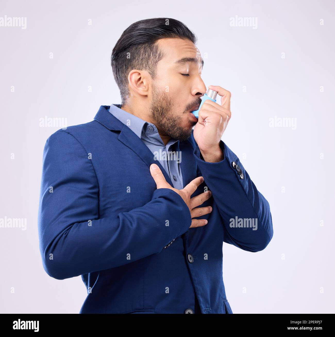 Business man breathe asthma pump in studio, medical health risk and